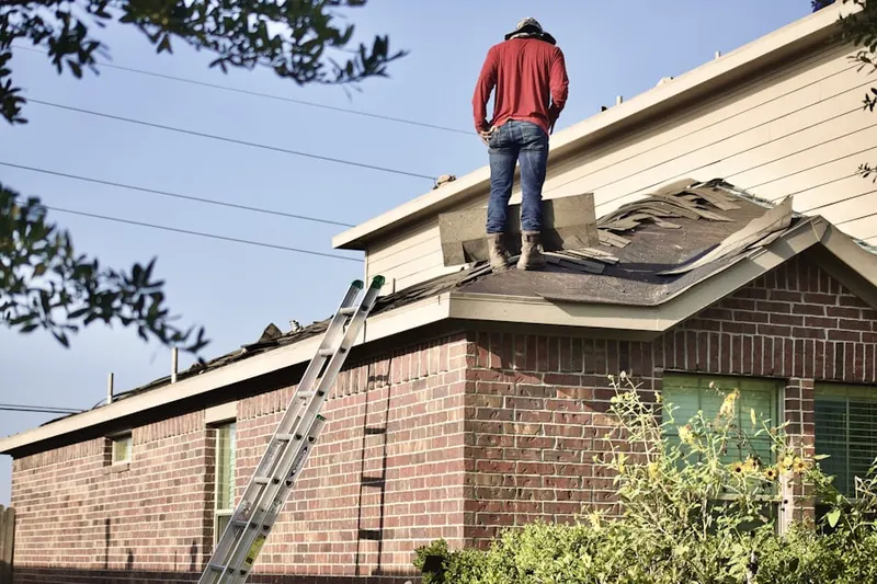 Professional roofer working on a residential roof in Georgetown Village